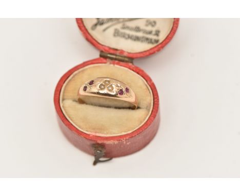 A YELLOW METAL GARNET AND SPLIT PEARL RING, detailed with a floral pattern set with garnets and split pearls, to a polished b