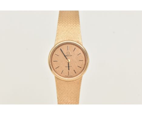 A LADIES 9CT GOLD 'OMEGA' QUARTZ WRISTWATCH, round textured gold dial signed 'Omega Quartz', baton markers, blue steel hands,