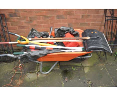 A PLASTIC WHEELBARROW CONTAINING GARDEN TOOLS including a stainless steel spade, tree loppers, a snow shovel, hedge clippers 