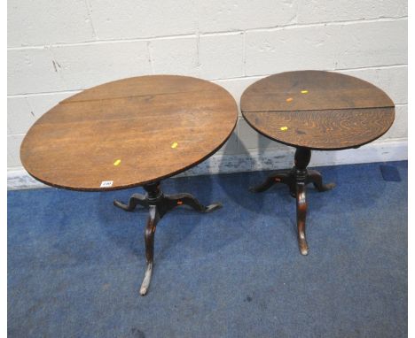 TWO GEORGIAN OAK TILT TOP TRIPOD TABLES, raised on turned supports, largest diameter 80cm x height 71cm, condition report: bo