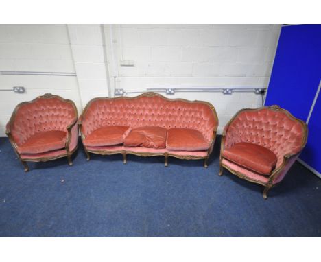 A FRENCH MAHOGANY AND PINK UPHOLSTERED THREE PIECE LOUNGE SUITE, comprising a three seater sofa, 196cm, and a pair of armchai