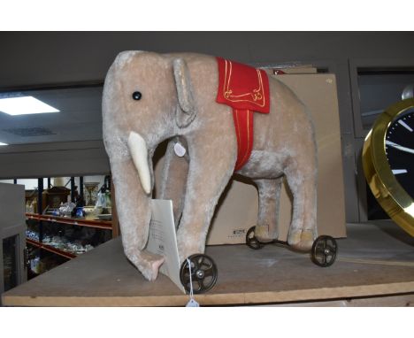 A BOXED LIMITED EDITION REPLICA STEIFF 'ELEPHANT ON WHEELS 1903/04', comprising a grey elephant crafted from mohair, cast whe