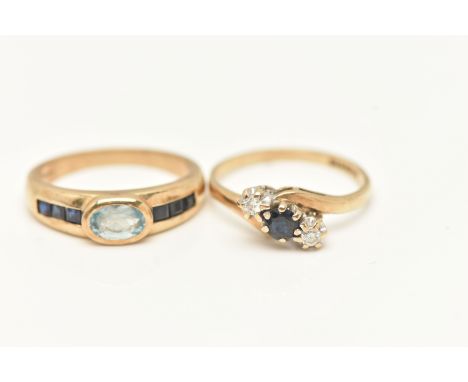 TWO 9CT GOLD GEM SET RINGS, the first set with an oval cut light blue topaz, collet set and flanked with square cut deep blue
