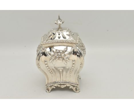 A LATE VICTORIAN SILVER TEA CADDY, of bombé form, pull off cover with knop finial, repoussé decorated throughout with foliate
