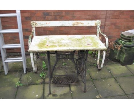 A CAST IRON SINGER TREADLE BASE FITTED WITH A WHITE MARBLE TOP and a vintage wrought iron garden bench with metal slats, tabl