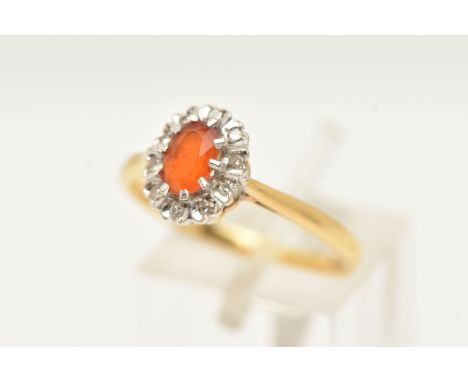 AN 18CT GOLD GEM SET RING, an oval cut fire opal, prong set in white gold, set with a surround of ten single cut diamonds, le