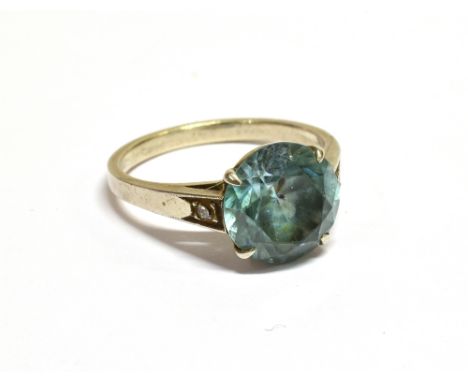 A MID 20TH CENTURY GOLD, BLUE ZIRCON AND DIAMOND RING centred with a round zircon-cut pale-blue zircon approx. 9.5mm diameter