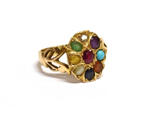 A MODERN MULTI-GEM OVAL CLUSTER RING  the head centred with an oval mixed-cut ruby within an eight stone surround including, 