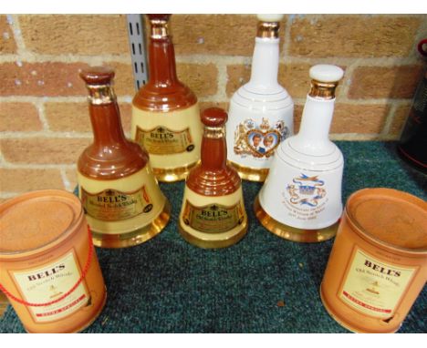 [WHISKY]. SEVEN BELL'S WHISKY DECANTERS BY WADE  including Royal commemoratives for the Marriage of Prince Charles &amp; Lady