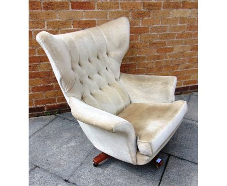 G-PLAN MODEL 6250 SWIVEL ARMCHAIR  with beige button upholstery, on four prong wooden base with casters