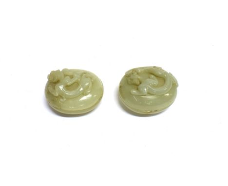 A PAIR OF CARVED JADE LIDDED POTS  relief decorated with dragons, 5.5cm long