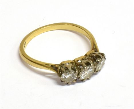 AN EARLY TO MID 20TH CENTURY GOLD AND DIAMOND THREE STONE RING the graduated early modern round brilliants approx. 0.33cts, 0