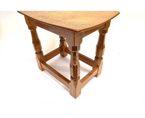 ROBERT 'MOUSEMAN' THOMPSON: A CARVED OAK STOOL  with adzed and dished oblong top, supported on four octagonal legs with box s