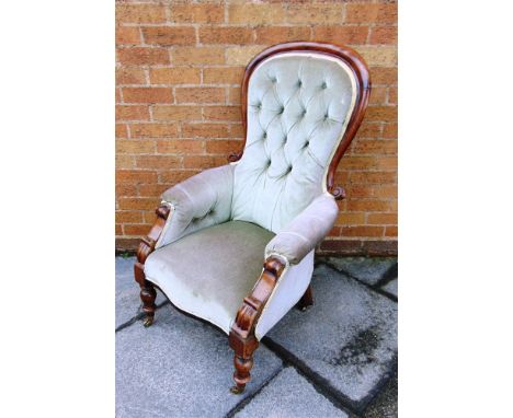 A VICTORIAN BUTTON UPHOLSTERED ARMCHAIR  on turned supports