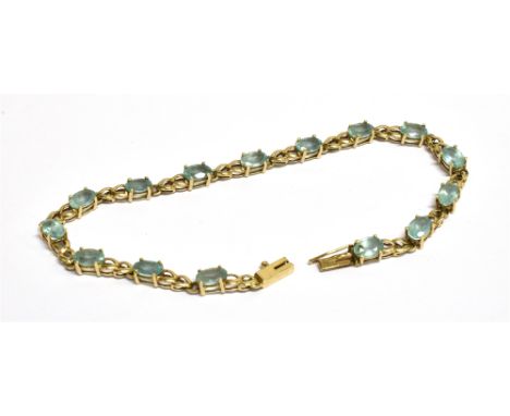 A MODERN 9CT GOLD AND PALE BLUE TOPAZ BRACLET The 15 oval mixed-cut stones claw set with oval inter-links, post 2000 London h