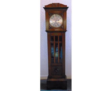 AN OAK CASED 8-DAY GRANDMOTHER CLOCK  with Westminster chime, the silvered dial with Arabic numerals, the trunk with bevelled