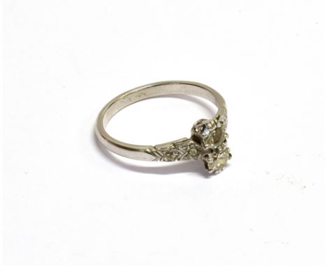 AN EARLY 20TH CENTURY PLATINUM AND DIAMOND TWO STONE RING  with diamond shoulders, the two principle early modern round brill