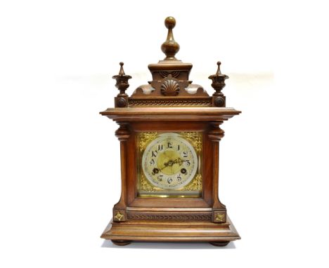 A CONTINENTAL MANTLE CLOCK  the 8-day Junghans movement striking on a coiled gong, in a carved walnut architectural case, 33c