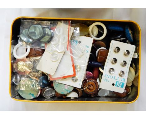 Two vintage tins containing buttons, two other tins containing buttons and a needlework guide book with a needlework help boo