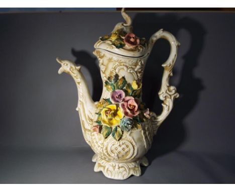 A large Capodimonte Pitcher with applied floral decoration, dragon spout and a cover, stamped to the base, approx 46cm (h) Th