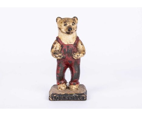 An American cast-iron I.H. Harvester Louisville bear, circa 1949, for a tractor company, in dungarees —4 ½in. (11.5cm.) high