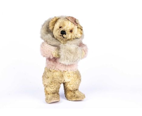 A rare Chiltern Skater musical Teddy Bear, late 1930s, with blonde artificial silk plush, orange and black glass eyes, pronou