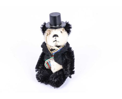 A rare post-war US exclusive Schuco miniature Ambassador Diplomat Panda Teddy Bear, with black and white mohair, black pin ey