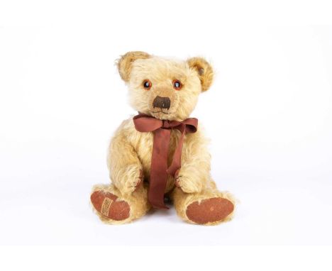 A 1930s Merrythought Teddy Bear,  with golden mohair, orange and black glass eyes, pronounced muzzle, black stitched nose, mo