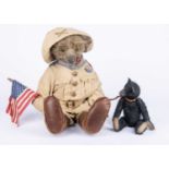 A Sue Lain (USA) Teddy Roosevelt Bear in Rough Rider uniform and black bear cub, circa 2001,