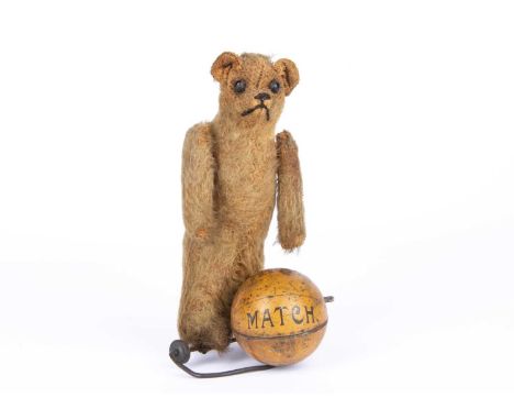 A rare Schuco clockwork football playing Teddy Bear, 1920s,  with golden mohair, black boot button eyes, pronounced muzzle, b