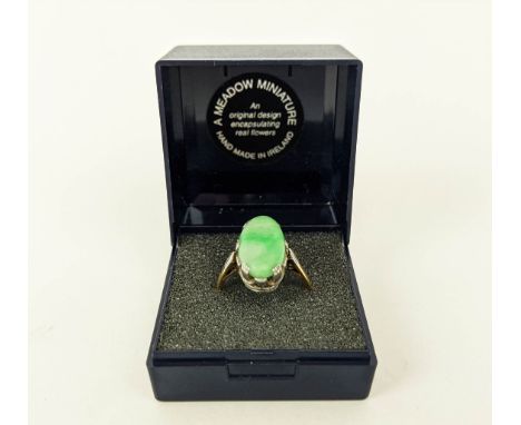 AN 18CT GOLD AND JADE SET DRESS RING, the single jade cabouchon in a white metal pierced setting, ring size P, 6.3 grams. 