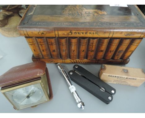 A treen souvenir box containing bone napkin rings, a Mauthe travel clock etc