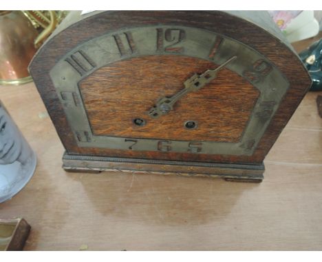 An Edwardian mantel clock with brass face and hands