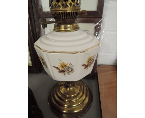 A Duplex brass based oil lamp with ceramic well