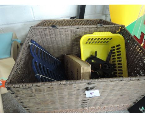 A basketware hamper containing door furniture, cast recipe stand and vintage childs volume 