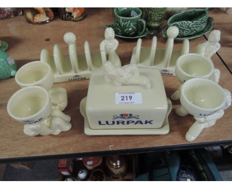 A collection of Lurpak ceramic advertising table ware including toast racks, butter dish and egg cups