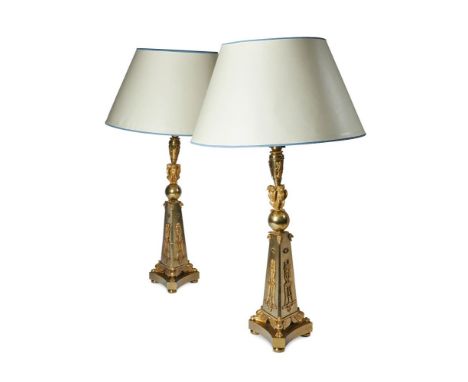 A PAIR OF GILT BRASS TABLE LAMPS IN THE EMPIRE STYLE LATE 19TH CENTURY AND LATER The fitment above the engine turned socket s