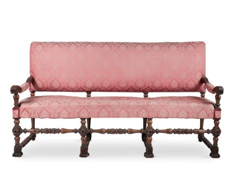AN OAK SOFA IN ITALIAN TASTE19TH CENTURY,The rectangular padded back and seat flanked by foliate and acanthus carved padded a