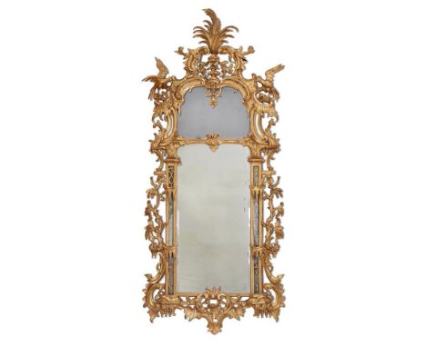 A CARVED GILTWOOD MIRROR LATE 18TH/ EARLY 19TH CENTURY, IN THE MANNER OF THOMAS CHIPPENDALE with divided bevelled arched rect