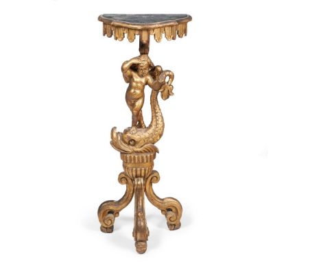 A NORTH ITALIAN GILTWOOD TORCHERE,19TH CENTURY, The shaped bowed top on stem carved with a wing  putto  resting  on  a  dolph