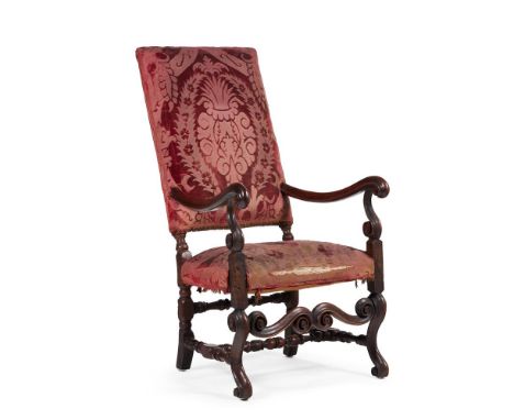 A CONTINENTAL WALNUT HIGH BACK ARMCHAIR18TH CENTURYThe rectangular padded back and upholstered seat on turned baluster stretc