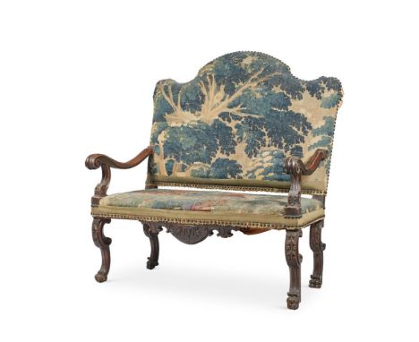 A CONTINENTAL WALNUT AND TAPESTRY UPHOLSTERED SETTEELATE 17TH AND LATERThe arched padded back and seat covered in blue ground