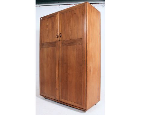  A stunning light beech and elm wood Ercol two door ' Windsor pattern ' wardrobe, fitted with twin full length doors. Measure