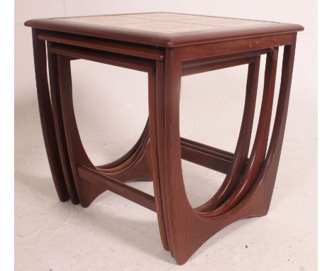 A 1970's G-Plan Kelso teak and tile top nest of tables. The tables of graduating form with tiled large table, plain smaller t