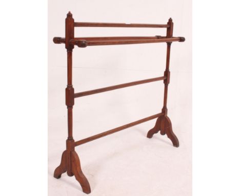 A Victorian mahogany towel rail stand with finial tops having hexagonal rails to centre. Measures: 83cm x 83cm x 24cm.