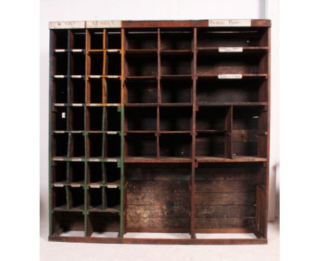 A 20th century vintage purpose built garage sectional pigeon hole / parts storage shelving system, various sized holes retain