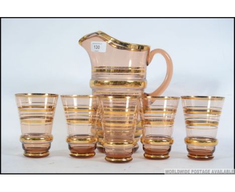A vintage 20th century glass Lemonade set, consisting of glasses and pitcher with applied gilt decoration. Please see images.