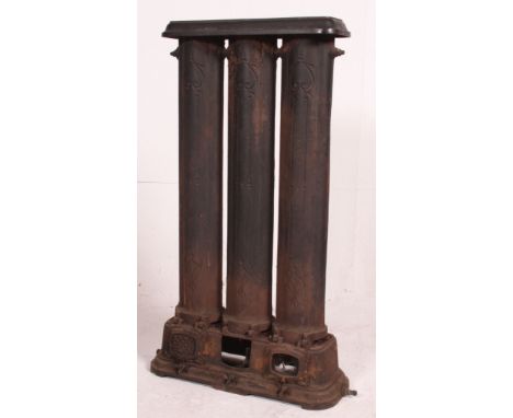 An early 20th century large cast iron architectural radiator with plinth base, three cylinder uprights and platform top.  Mea