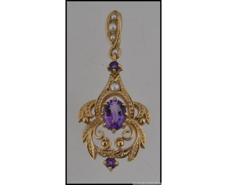 A hallmarked 9ct gold Art Nouveau pearl and amethyst drop necklace pendant . Hallmarked rubbed, tests 9ct. Measures 4.5cms. W