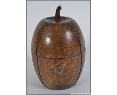 An unusual carved fruitwood tea caddy in the form of a melon having hinged top complete with the key.